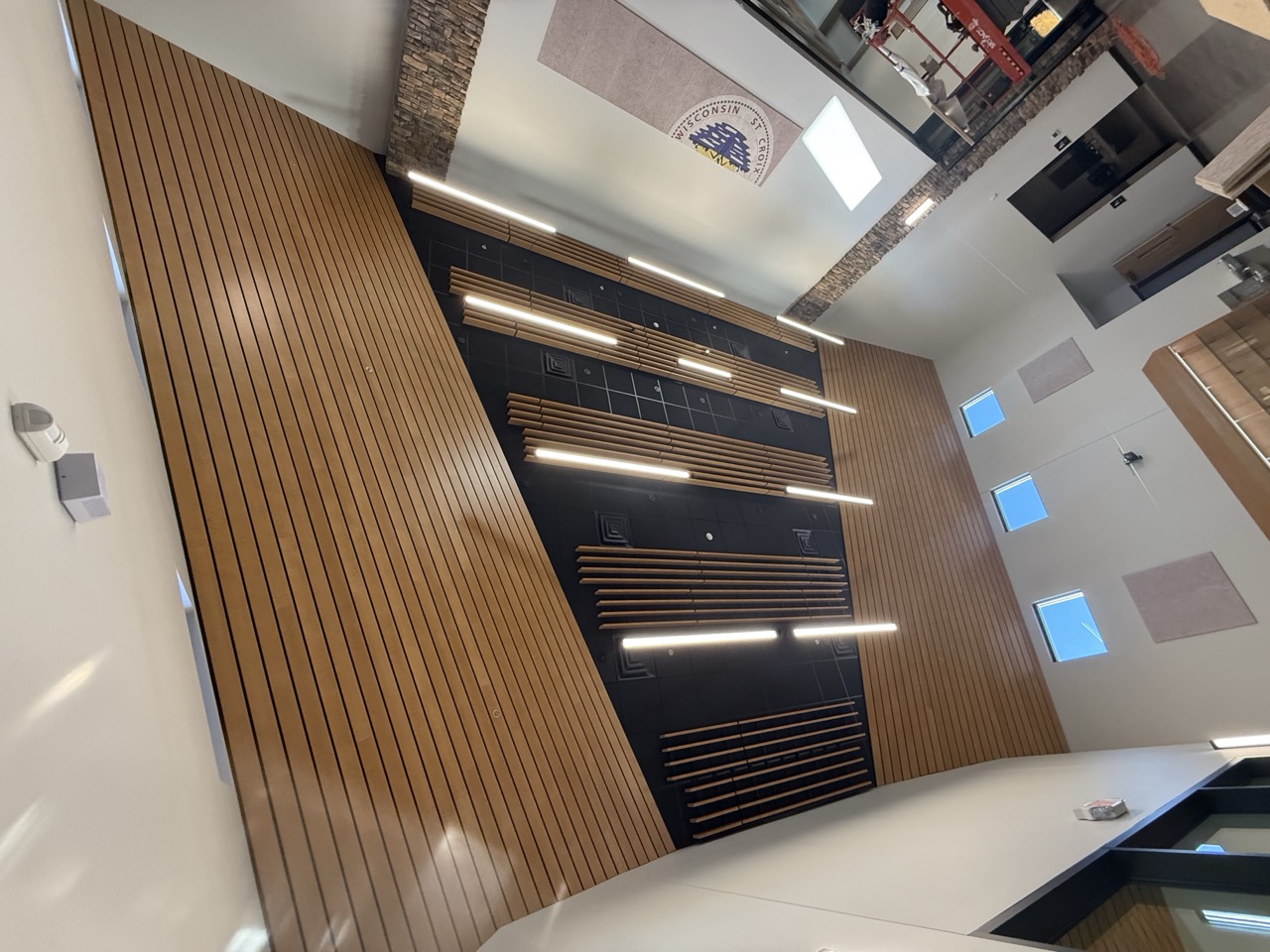 Suspended wood linear slat ceiling with integrated lighting